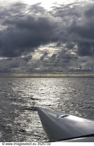 Storm clouds over sky and boat in sea