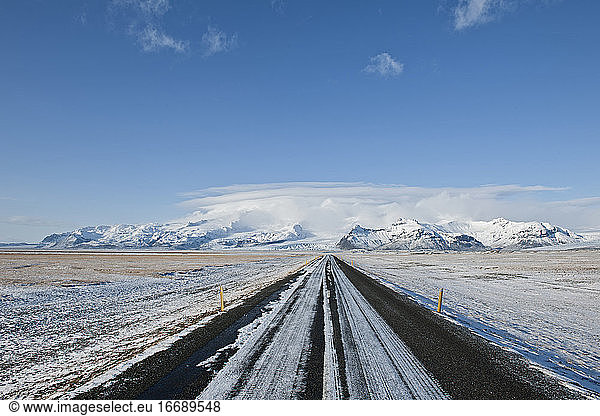 straight highway leading to majestic mountain in Iceland