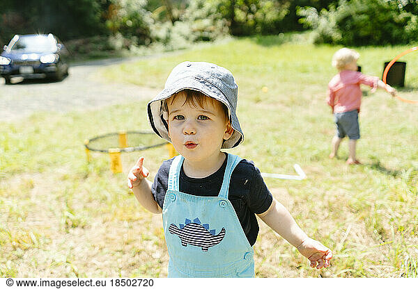 Straight on portrait of a young boy wearing a bucket hat