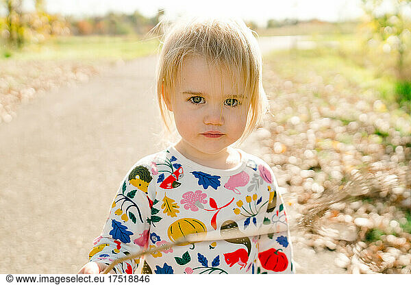 Straight on portrait of a young child on a fall day