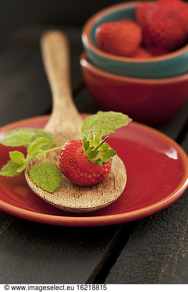 Strawberry on wooden spoon  close up