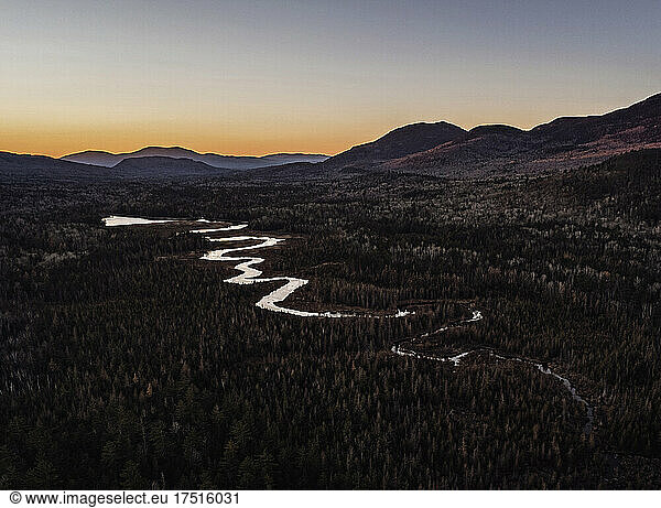 stream meanders through valley at sunset north maine woods