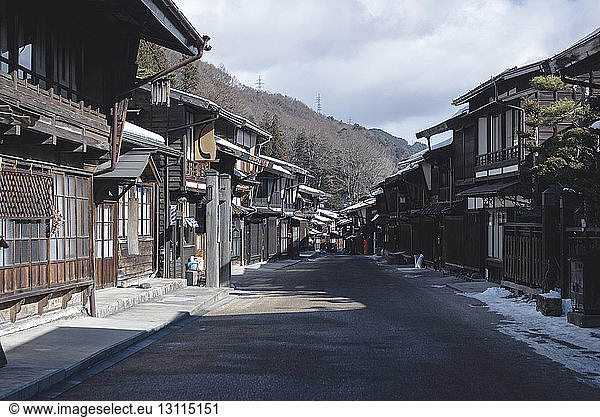 Street amidst houses during winter