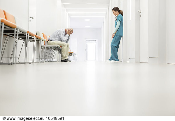 Stressed doctor and nurse in hospital corridor