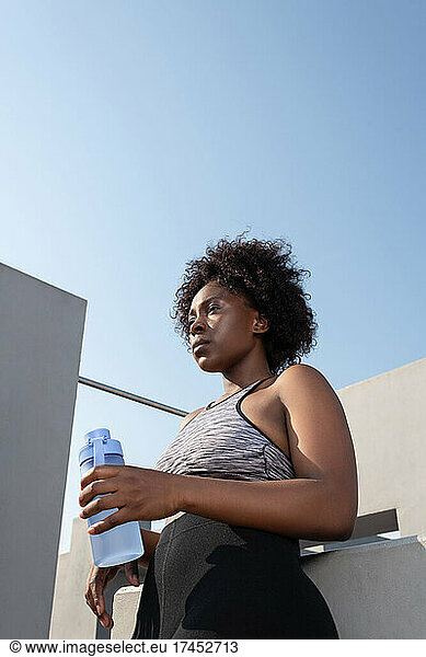 Strong African American sportswoman with water