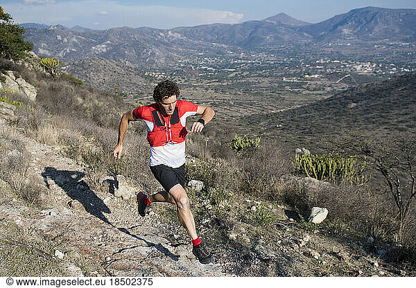 Strong athletic man trail running in the desert in El Arenal  Hidalgo  Mexico.