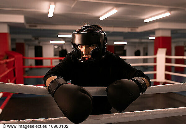 Strong female boxer in protective gear