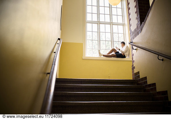 Student (14-15) sitting by window