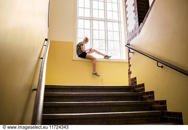 Student (14-15) sitting by window