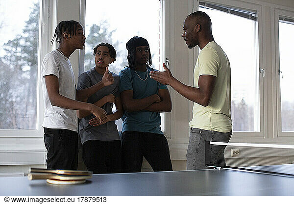Students and coach interacting with each other in games room