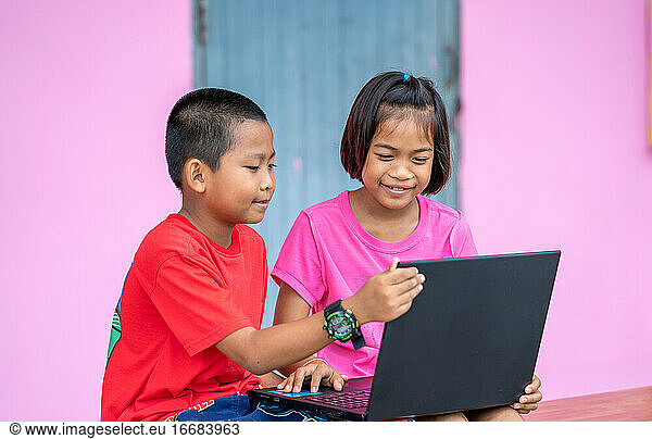 Students learning with laptop computer in elementary school clas