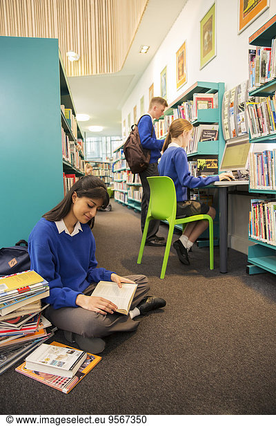 Students using computer and learning in library