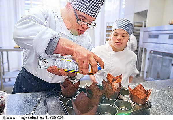 Students with Down Syndrome baking muffins in kitchen