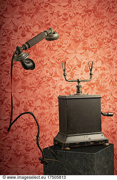 Studio shot of antique landline phone with levitating receiver