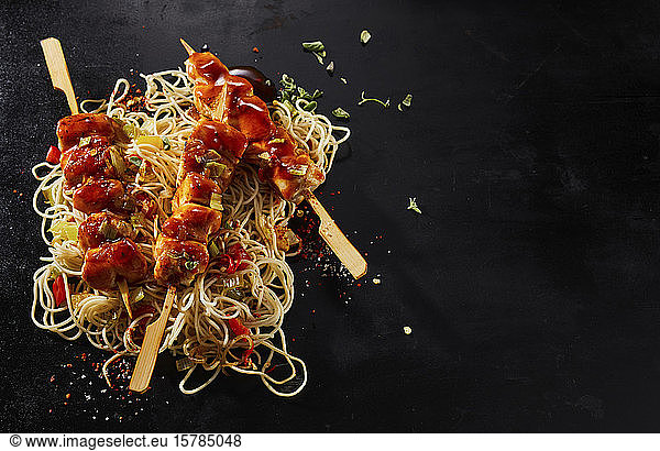 Studio shot of Asian style skewers and noodles