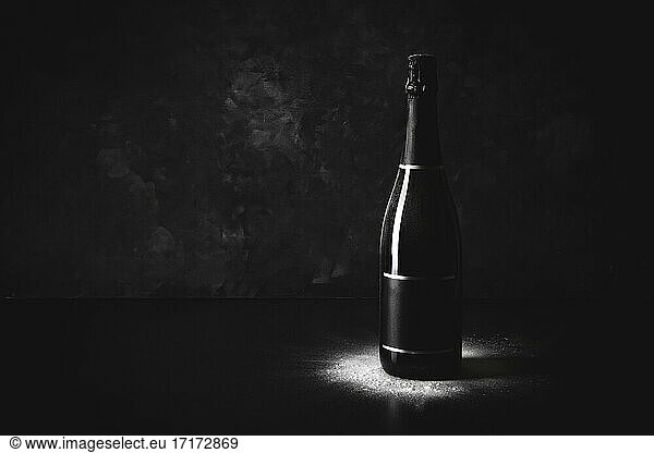 Studio shot of black bottle of champagne with blank label