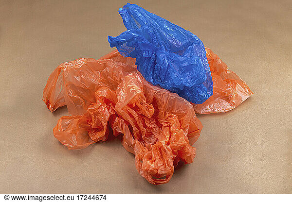 Studio shot of blue and orange plastic bags