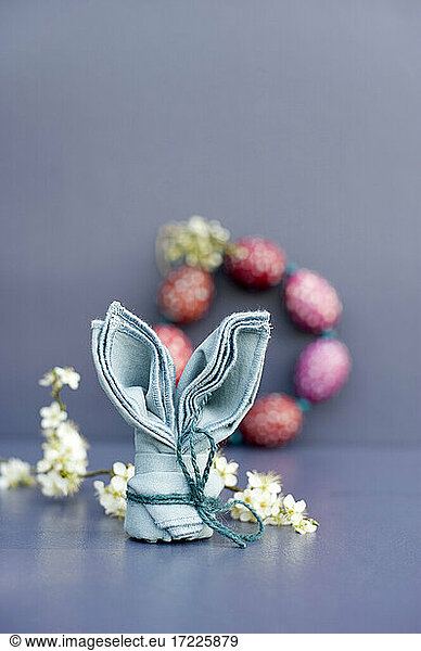 Studio shot of blue napkin folded into shape of Easter Bunny
