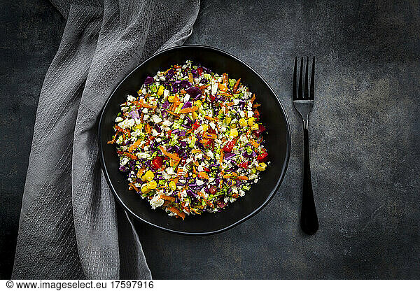 Studio shot of bowl of colorful vegan salad