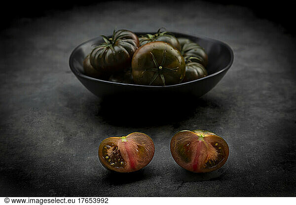 Studio shot of bowl of dark cabomar tomatoes