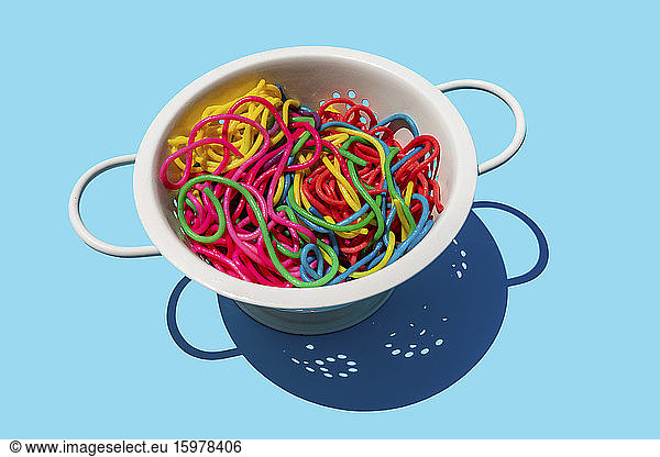 Studio shot of colorful pasta in colander