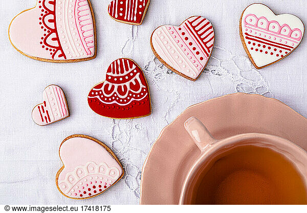 Studio shot of cup of tea and heart shaped cookies