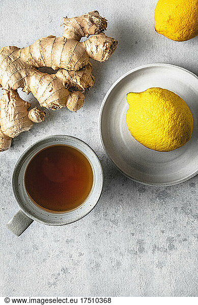 Studio shot of cup of tea  lemons and ginger root
