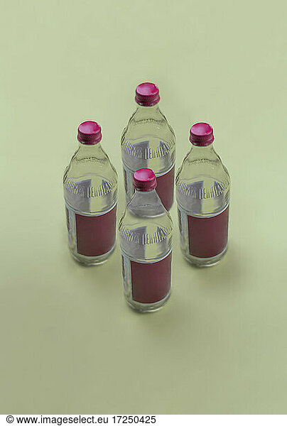 Studio shot of four empty glass bottles