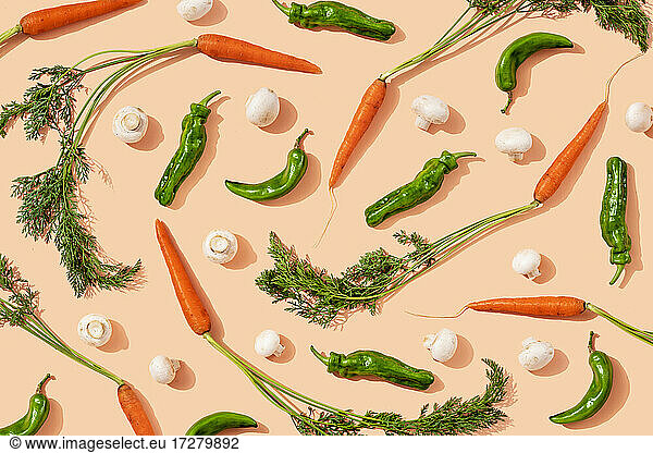 Studio shot of fresh green chili peppers  carrots and mushrooms