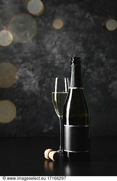 Studio shot of glass and bottle of champagne