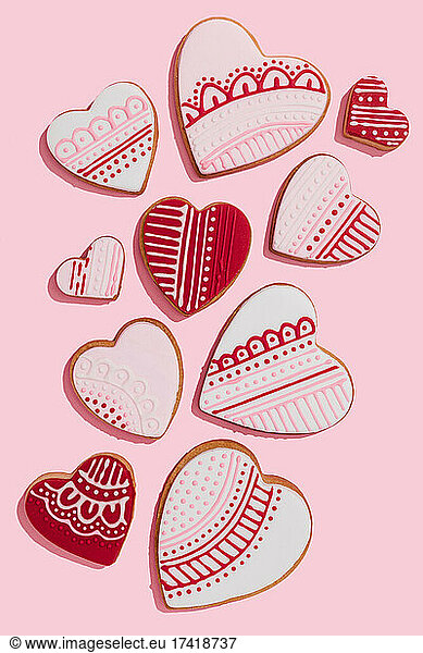 Studio shot of heart shaped cookies flat laid against pink background