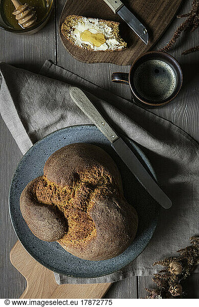 Studio shot of loaf of homemade pumpkin bread and mug of coffee