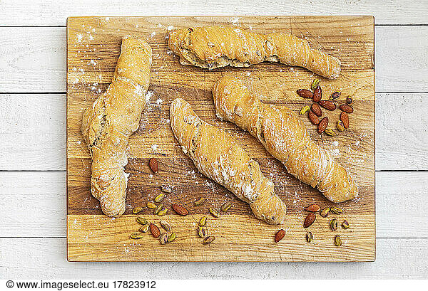 Studio shot of loaves of homemade Pain Paillasse bread with almonds and pistachios