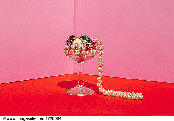 Studio shot of martini glass filled with expensive jewelry