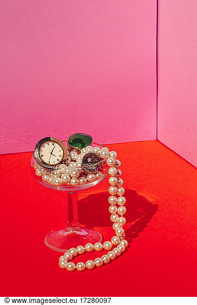 Studio shot of martini glass filled with expensive jewelry