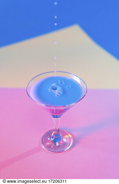 Studio shot of martini glass with blue liquid