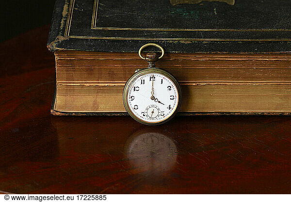 Studio shot of old book and antique pocket watch