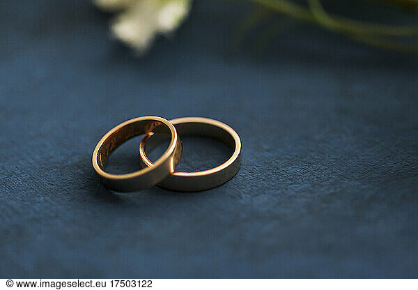 Studio shot of pair of golden wedding rings