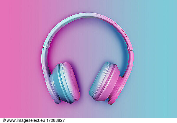 Studio shot of pink and blue wireless headphones