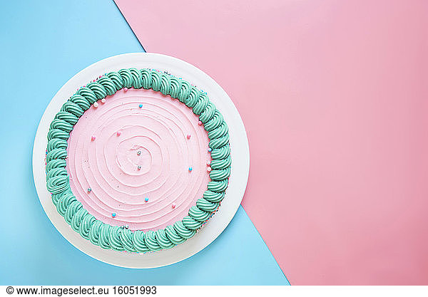 Studio shot of pink birthday cake