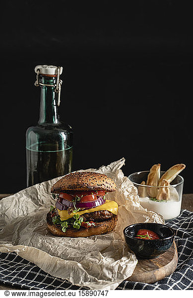 Studio shot of ready-to-eat hamburger with red bell pepper  onions and cheese