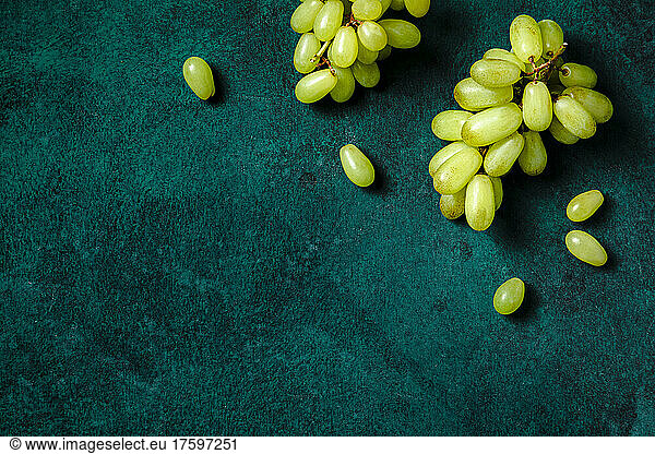 Studio shot of ripe grapes lying against green background