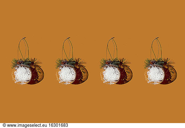 Studio shot of row of Christmas ornaments