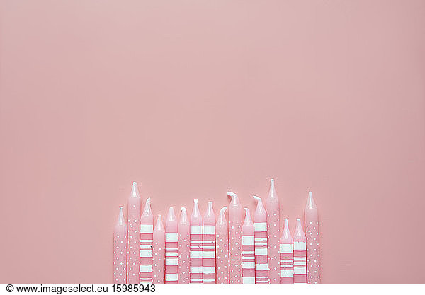 Studio shot of row of pink colored birthday candles
