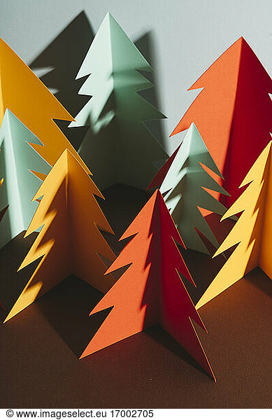 Studio shot of simple paper craft forest trees in autumn colors