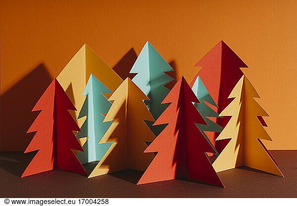 Studio shot of simple paper craft forest trees in autumn colors