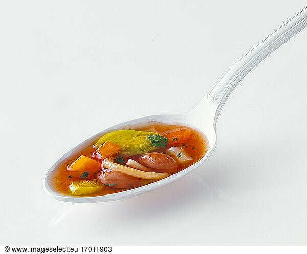 Studio shot of spoon of vegetable soup