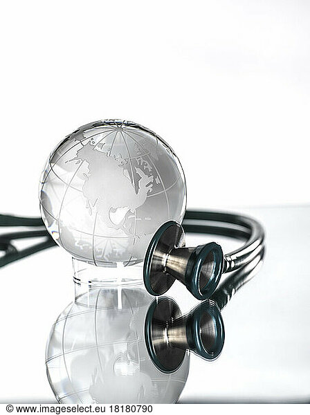 Studio shot of stethoscope pointed at glass globe