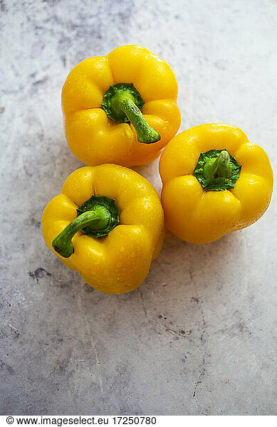 Studio shot of three yellow bell peppers