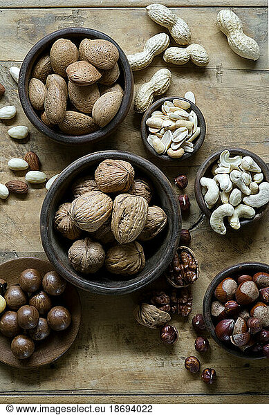 Studio shot of various nuts lying on wooden tray